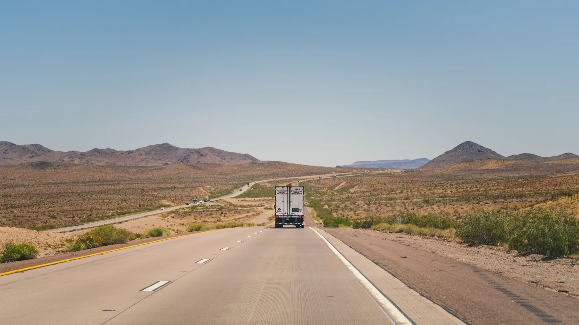 Freight truck traveling through an Arizona desert landscape