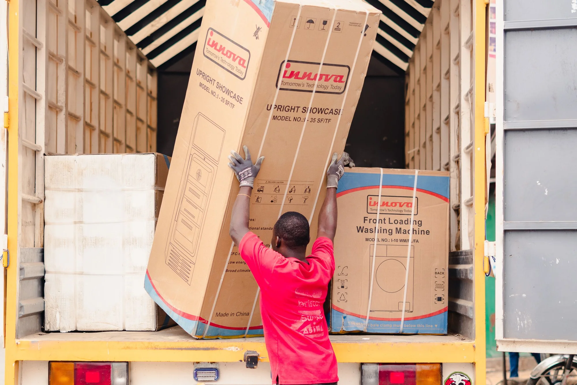 Worker loading packaged cargo into a truck